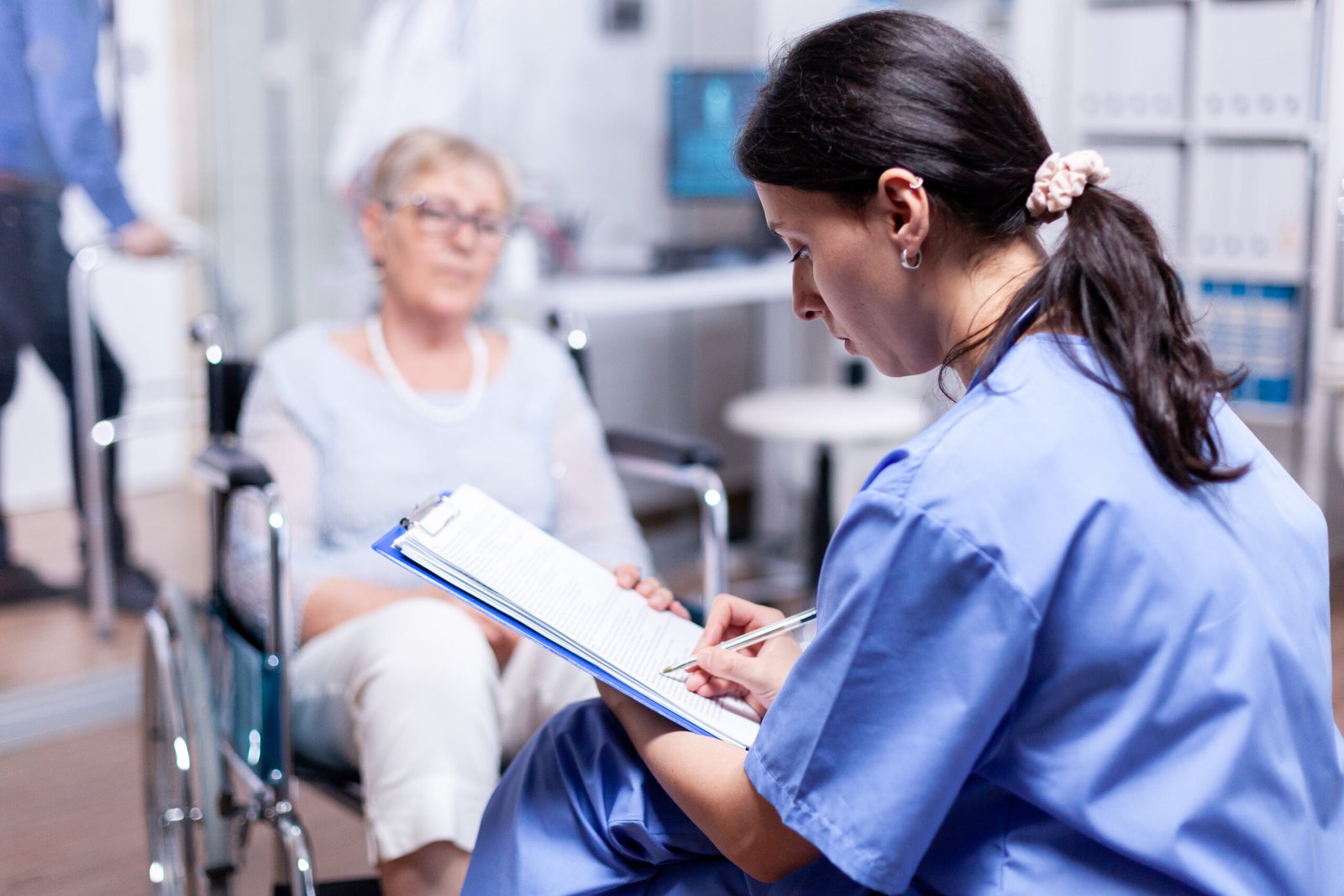 Nurse Writing Prescription Disabled Senior Woman Wheelchair After Medical Examination Scaled